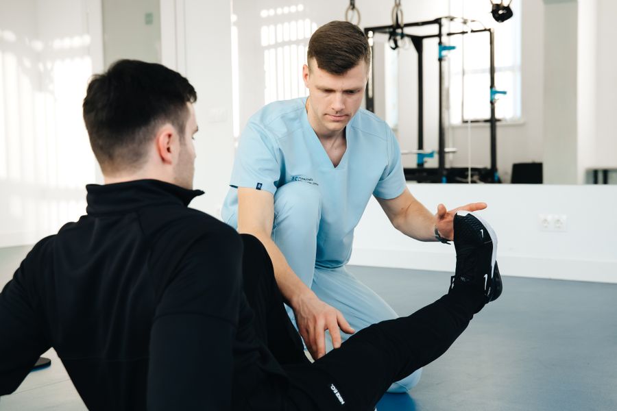 Stock photo demonstrating physiotherapist-assisted leg movement